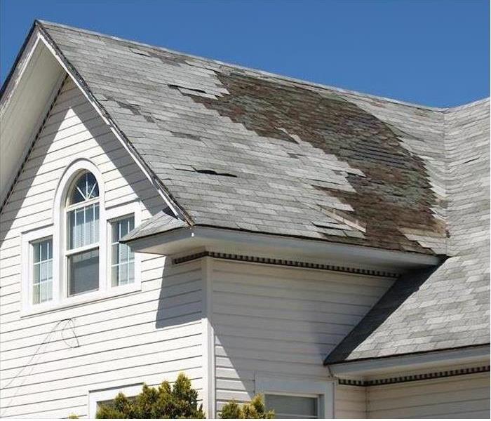 Home with damaged shingles 